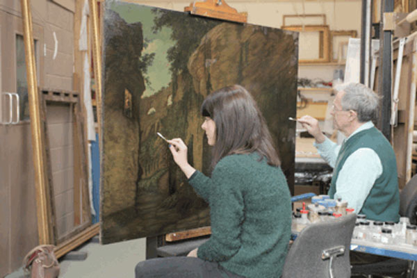  Conservators work on restoring one of Joseph Wright's Colosseum paintings. Courtesy of Derby Museums Trust.