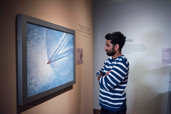visitor looks at art at the science museum