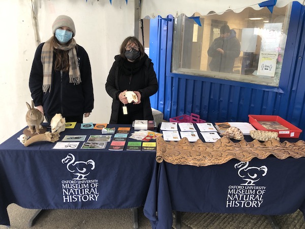 two people in masks at museum stall in football ground