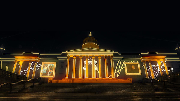 The image shows the front of the National Gallery building at night. The building is lit up with yellow lights highlight the columns and entrance. On either side of the entrance are digital light representations of artworks. 