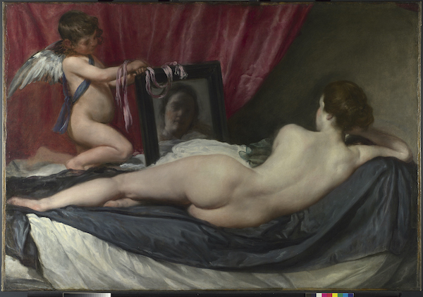 Velázquez's painting 'The Rokeby Venus' shows a naked woman lying stretched out on a couch. She looks away from us and gazes into a mirror where she can see her reflection. The mirror which is on the left is held by a putto (winged infant) who has pink ribbons draped on their arm and the top of the mirror. The curtain behind the mirror is red and the couch has blue and white sheets. The woman has long brown hair that is tied up. 