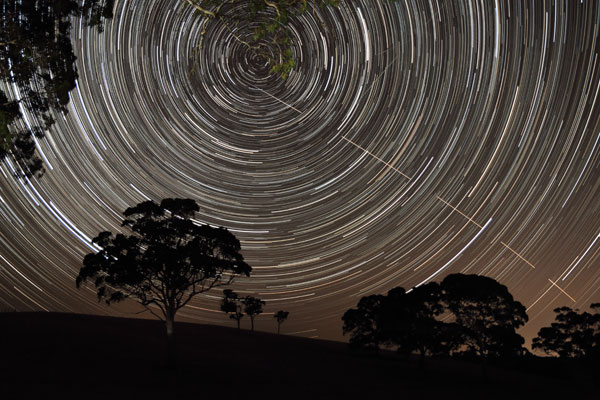 Just Missed the Bullseye © Scott Carnie-Bronca (Australia) The International Space Station (ISS) appears to pierce a path across the radiant, concentric star trails seemingly spinning over the silhouettes of the trees in Harrogate, South Australia.