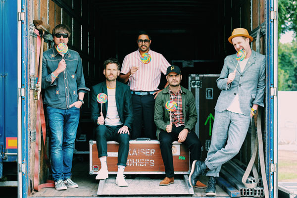 men pretending to eat lollipops in the back of a truck