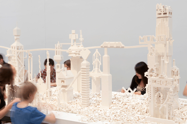white lego bricks built into tall city towers by visitors