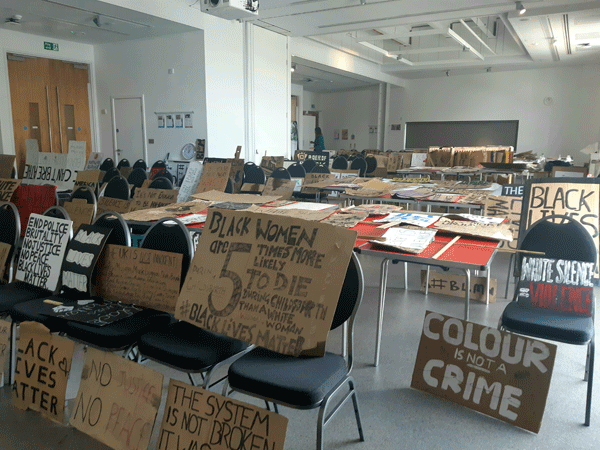 carboard signs from black lives matter protest in council offices