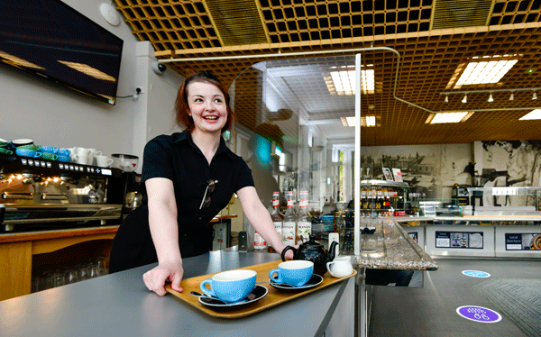 woman organises catering at museum cafe