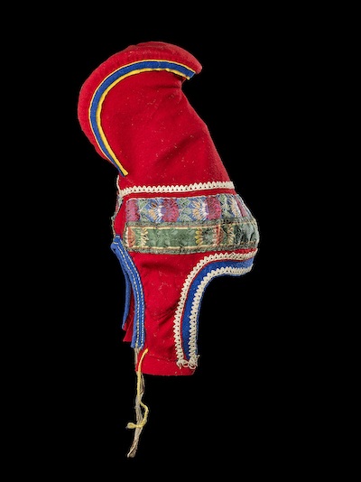 sami hat in bright red with blue and yellow curve at the top