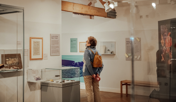 visitor stands in gallery