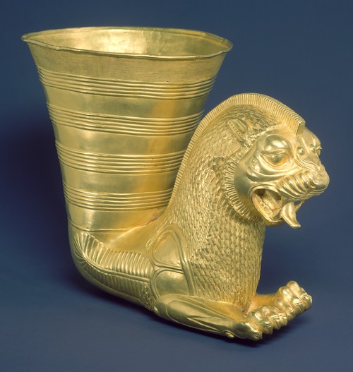 golden animal with hind parts shaped into open mouthed vessel