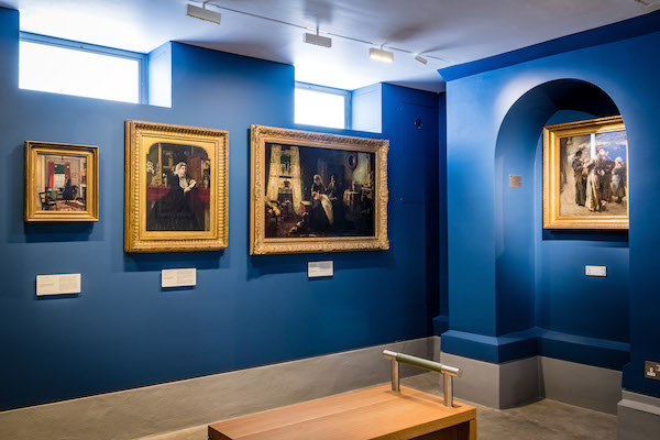 blue gallery with 19th century pictures of home life