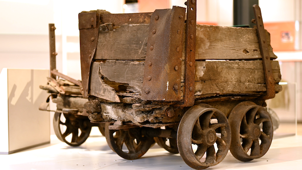 battered wood and iron mine cart