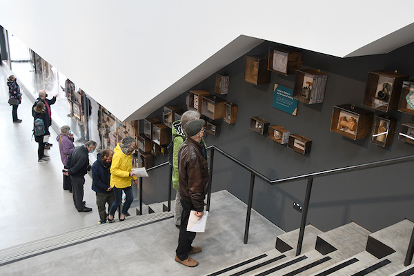 visitors climb the stairs at derby silk mill looking at exhibits on the walls