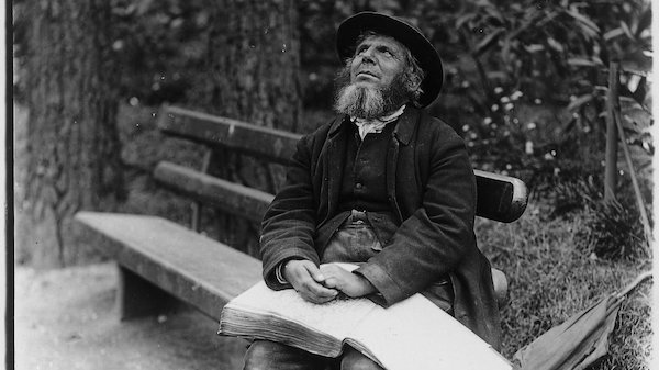 photograph of blind Victorian sitting with book of braille