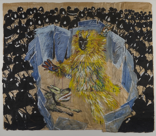 masked and yellow feathered spirit surrounded by policemen with riot shields and a barking dog