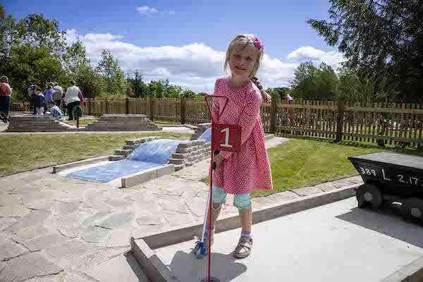 small girl at the crazy golf course