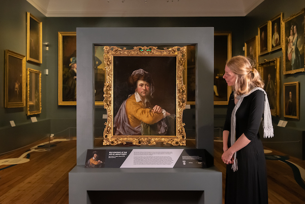 lucy bamford stands next to joseph wright self portrait