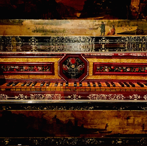 close up cropped photograph of a highly decorative piano 