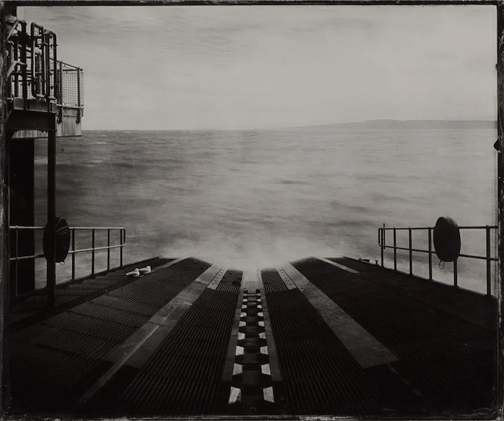 A black and white photo of the launch ramp into the sea.